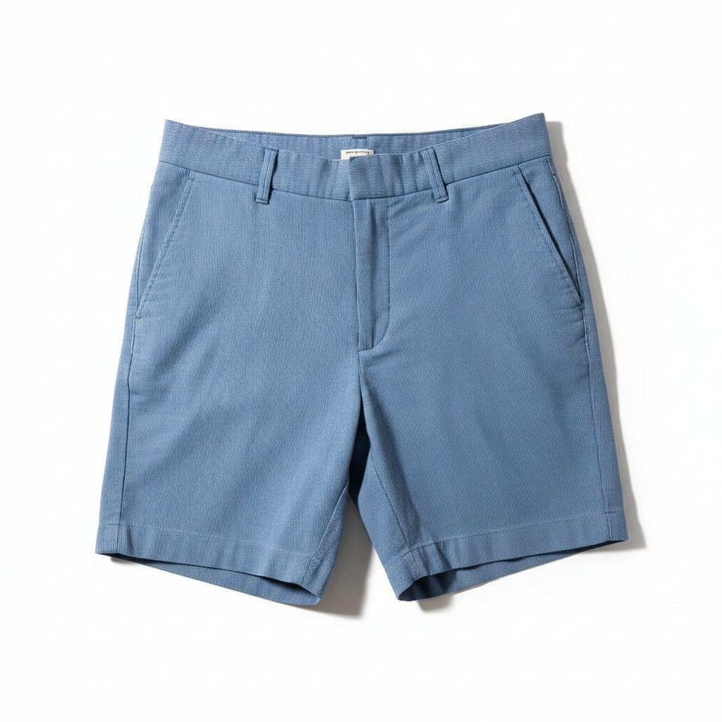 A pair of light blue chino shorts with a flat front, belt loops, and side pockets, laid flat on a white background.