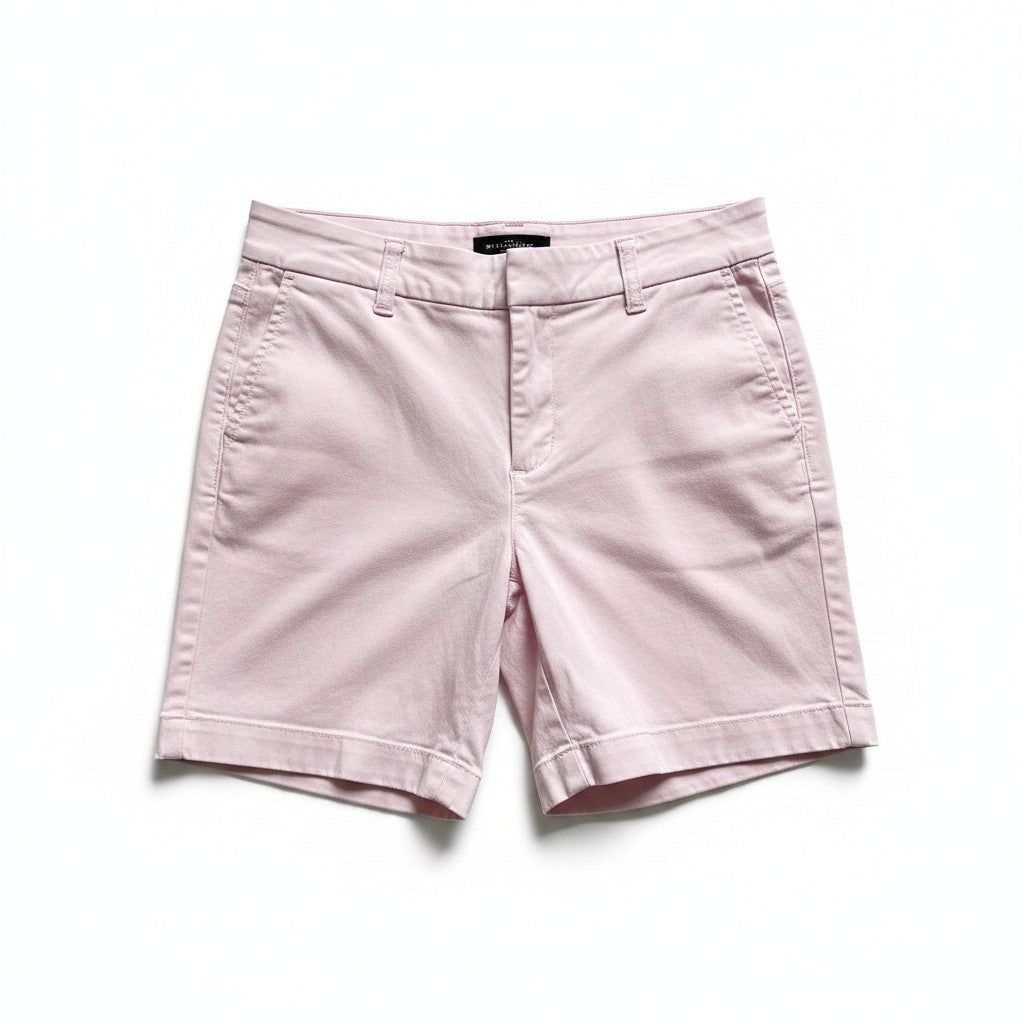 A pair of light pink chino shorts with a flat front, button closure, belt loops, and cuffed hems, laid flat on a white background.