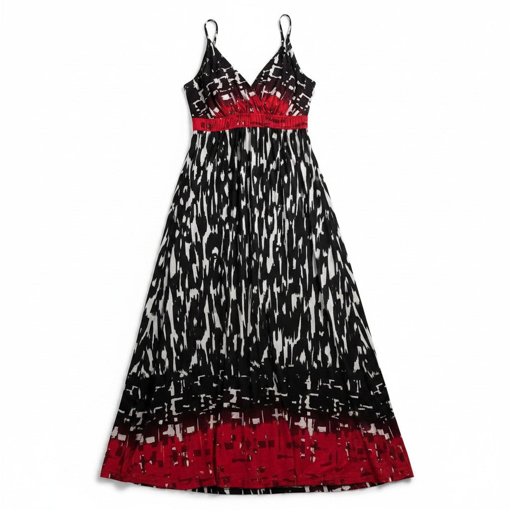 A sleeveless midi dress with thin spaghetti straps, featuring a black and white abstract brushstroke pattern with vibrant red bands at the waist and hem, displayed on a clean white background.