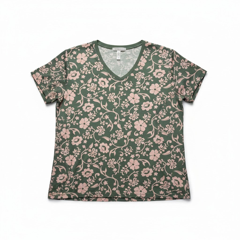 A women's short-sleeve V-neck t-shirt with an all-over floral vine pattern in dusty pink on a dark green background, laid flat against a white background.