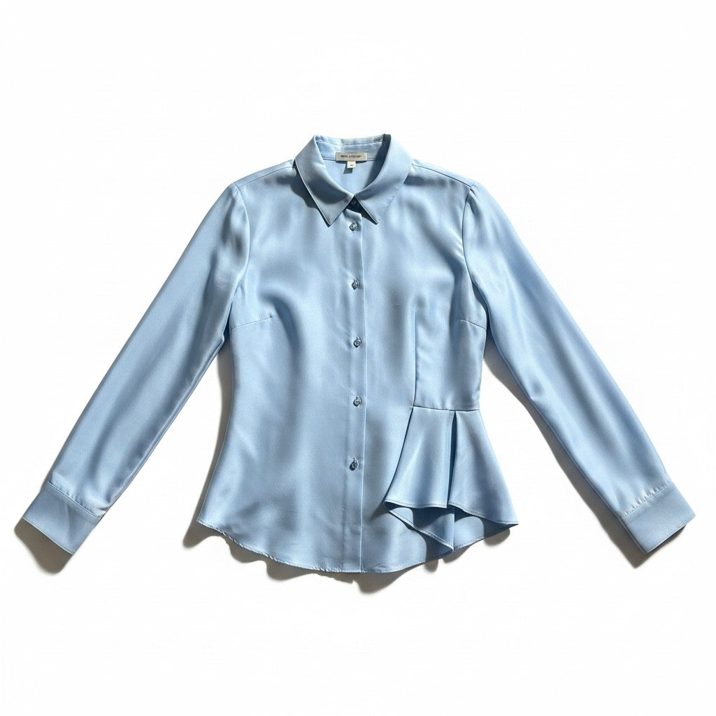 A light blue long-sleeve button-up blouse with a pointed collar, structured shoulders, and a peplum-style hem detail, laid flat on a white background.