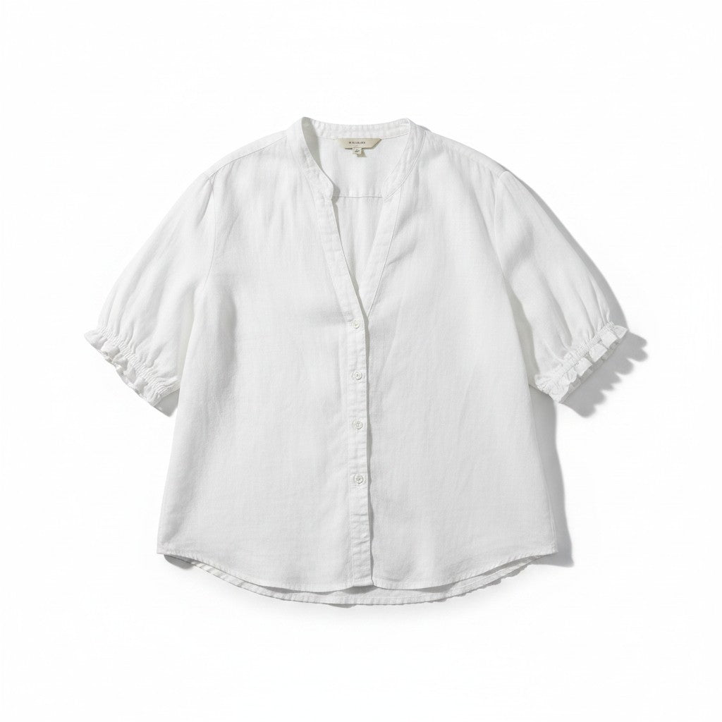 A white short-sleeve linen button-up blouse with gathered puff sleeves and a scalloped ruffle trim at the cuffs, shown flat on a white background.