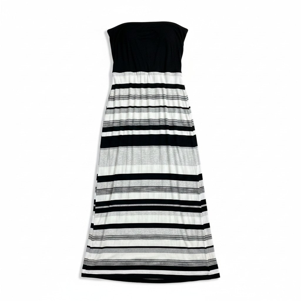 A strapless knit maxi dress with a solid black bodice and horizontal black, gray, and white stripes on a white background.