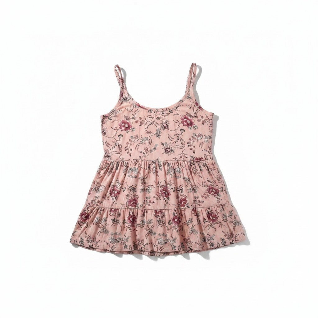 A pink tiered sleeveless dress with a delicate floral print, featuring thin shoulder straps and a ruffled hem, displayed flat against a white background.