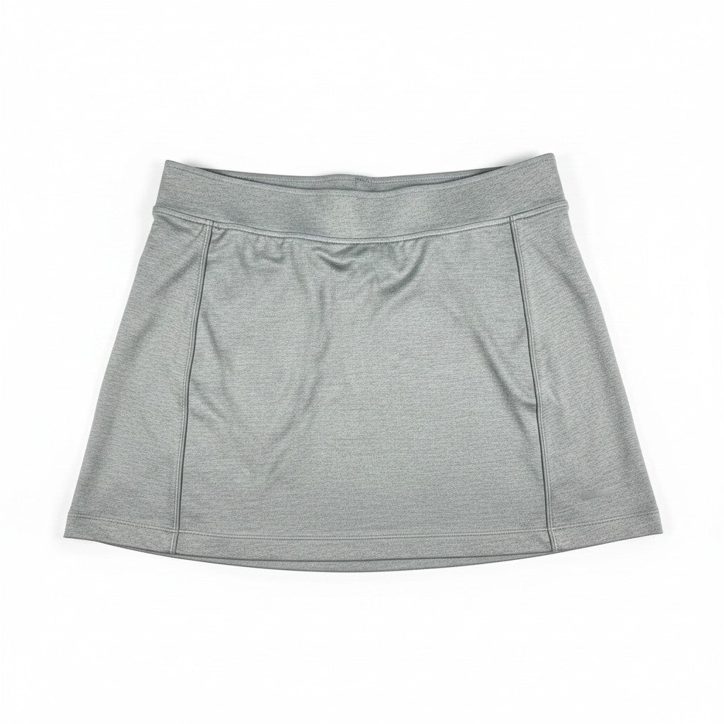 A light gray athletic skort with a wide elastic waistband and front seam details, laid flat on a white background.