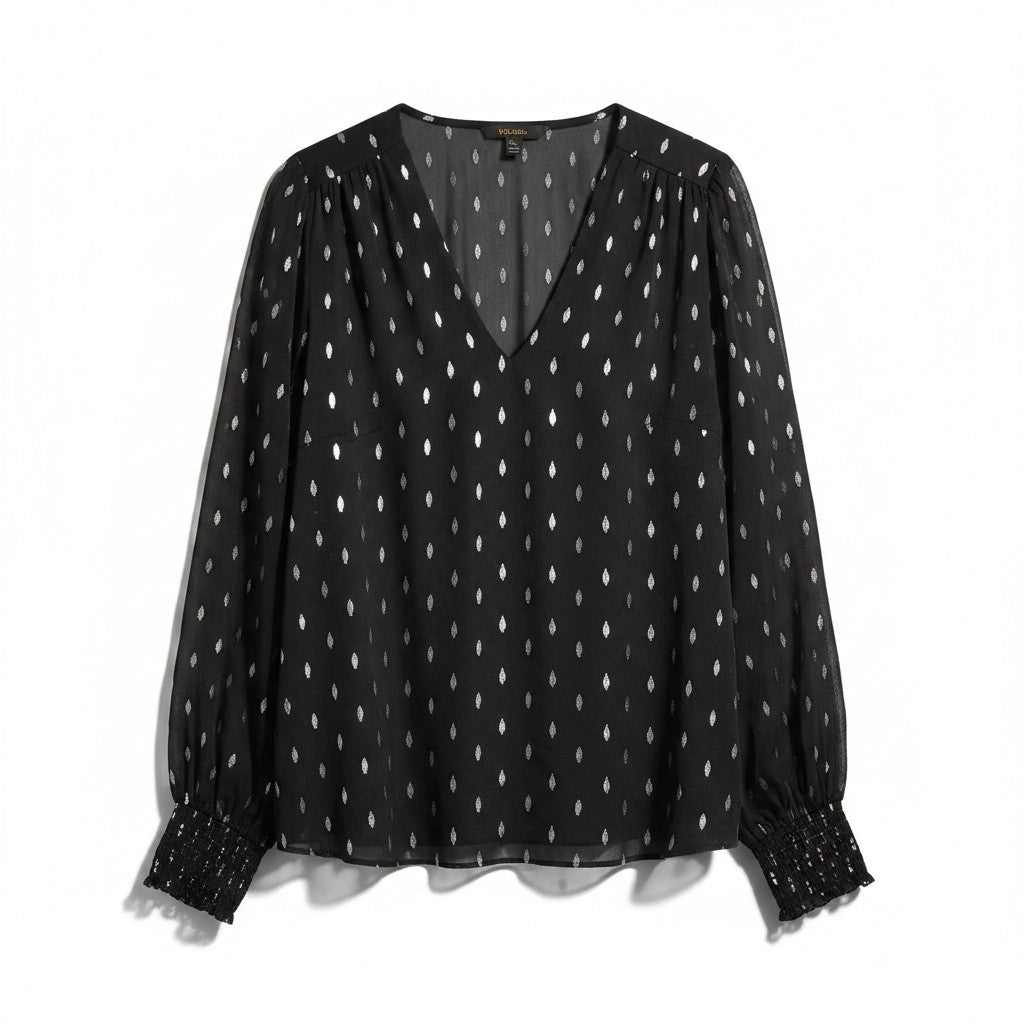 A black sheer long-sleeve blouse with a white dotted pattern, featuring a V-neckline and smocked cuffs, displayed against a plain white background.