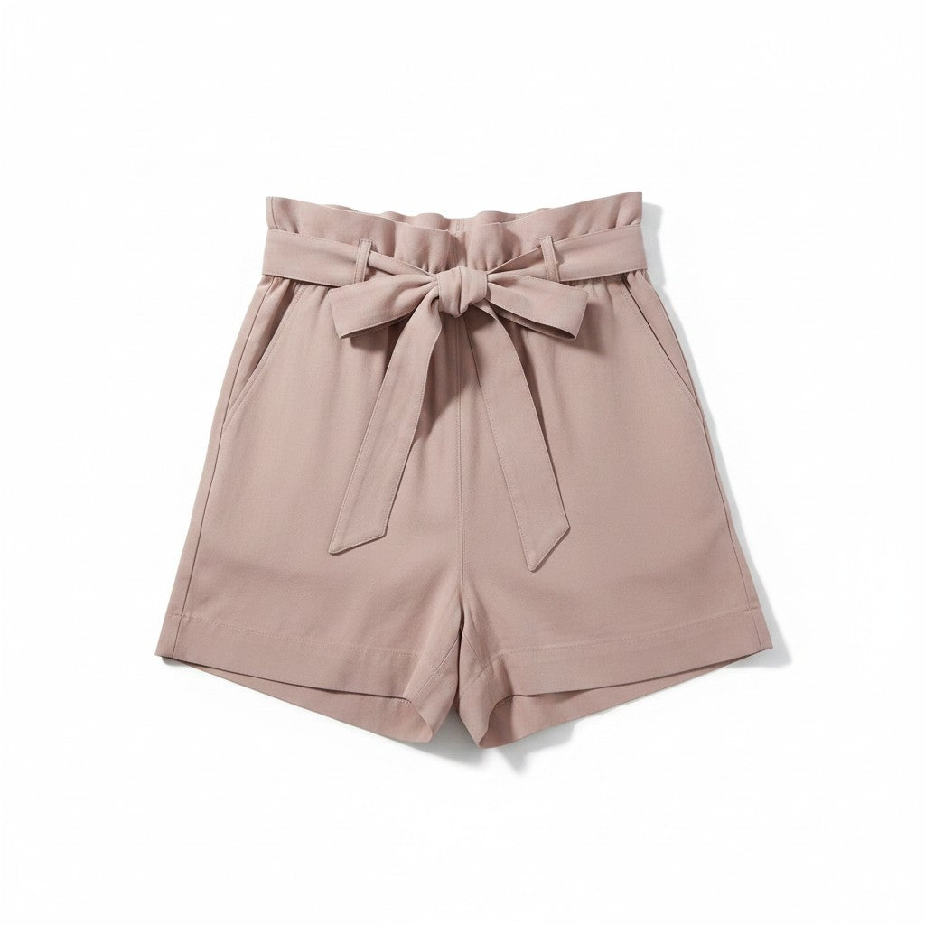 A pair of high-waisted shorts in a dusty rose pink color, featuring a paperbag-style waistband with a matching fabric tie bow, set against a plain white background.