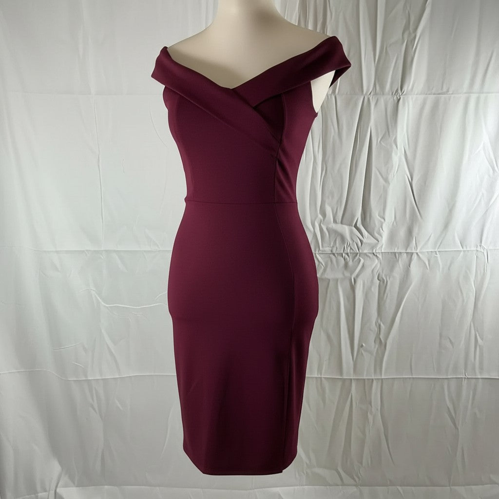 A fitted off-the-shoulder bodycon dress in deep burgundy, displayed on a cream mannequin torso against a wrinkled white fabric backdrop.