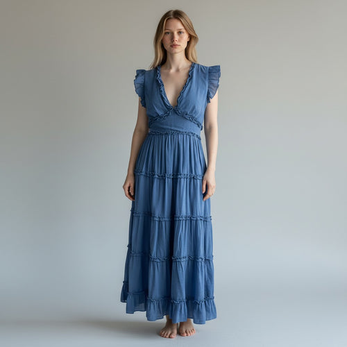 Woman wearing a blue dress against a plain background