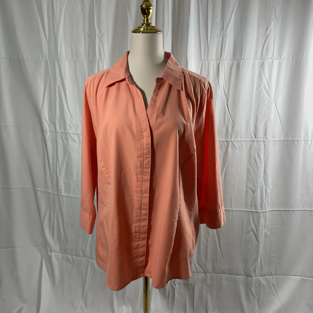 A coral pink button-down shirt with three-quarter sleeves, displayed on a white dress form mannequin against a wrinkled white backdrop.