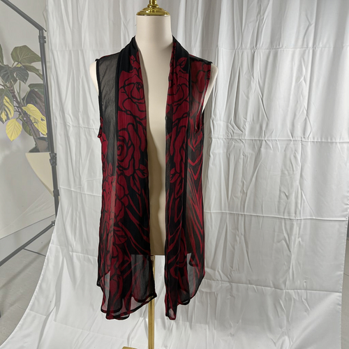 A sleeveless black mesh vest with a red rose pattern, displayed on a cream mannequin torso against a wrinkled white studio backdrop.