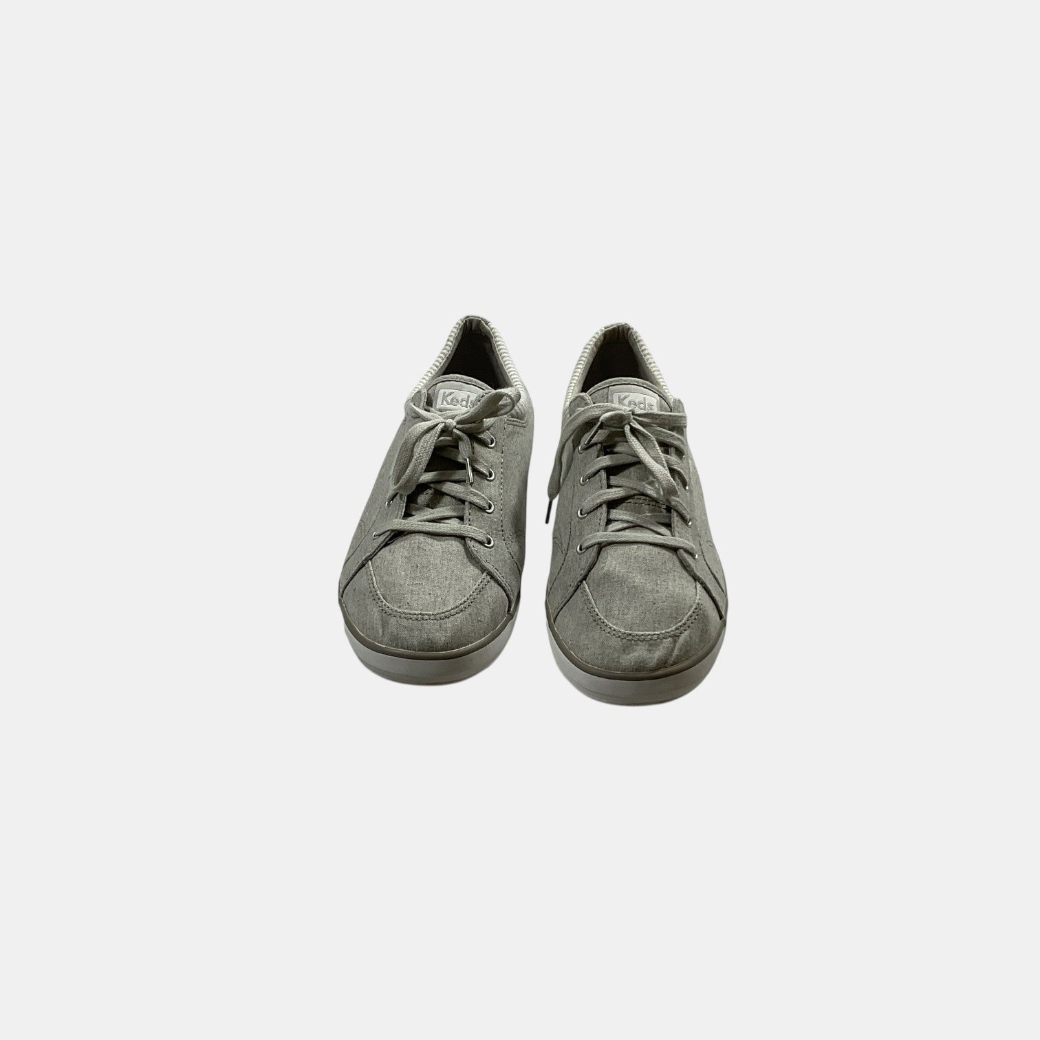 grey Keds sneakers on a white background