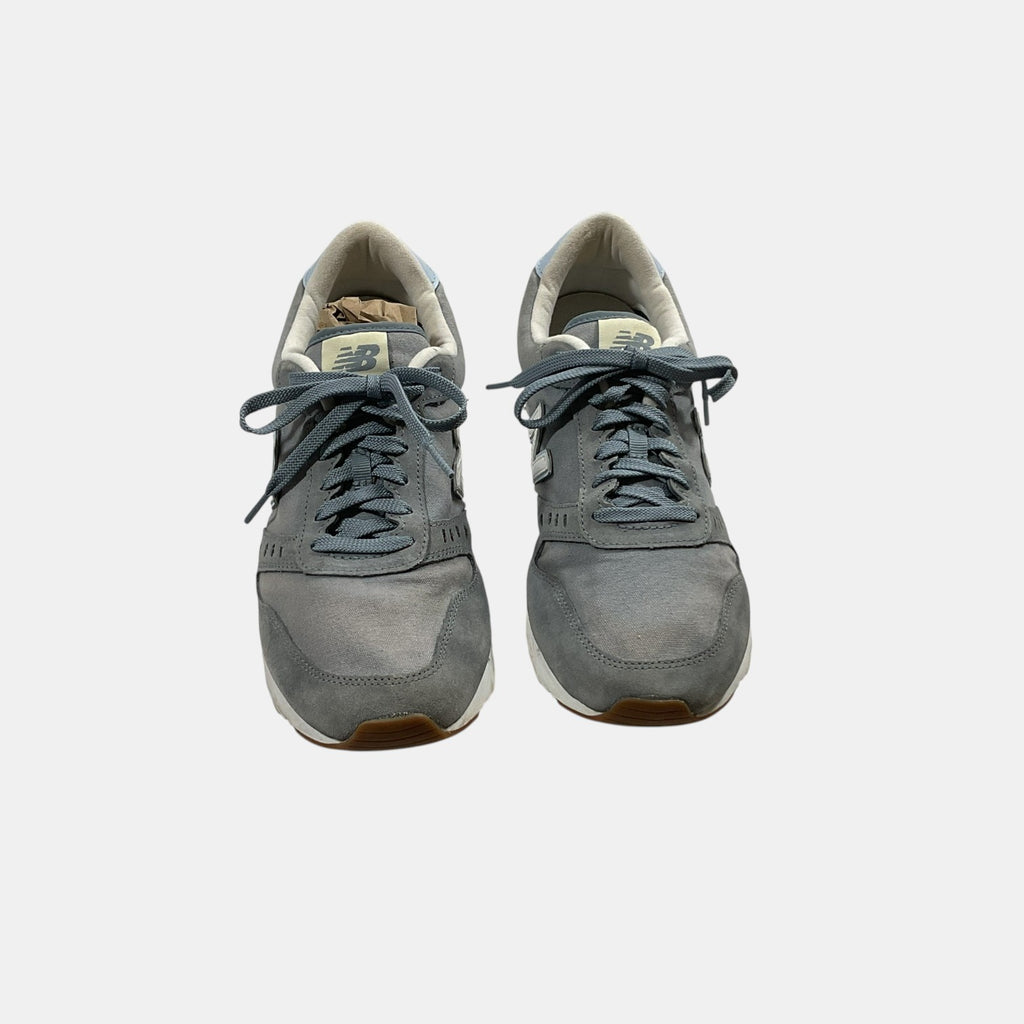 grey and blue New Balance Sneakers on a white background