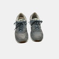 grey and blue New Balance Sneakers on a white background