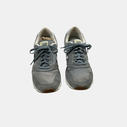 grey and blue New Balance Sneakers on a white background