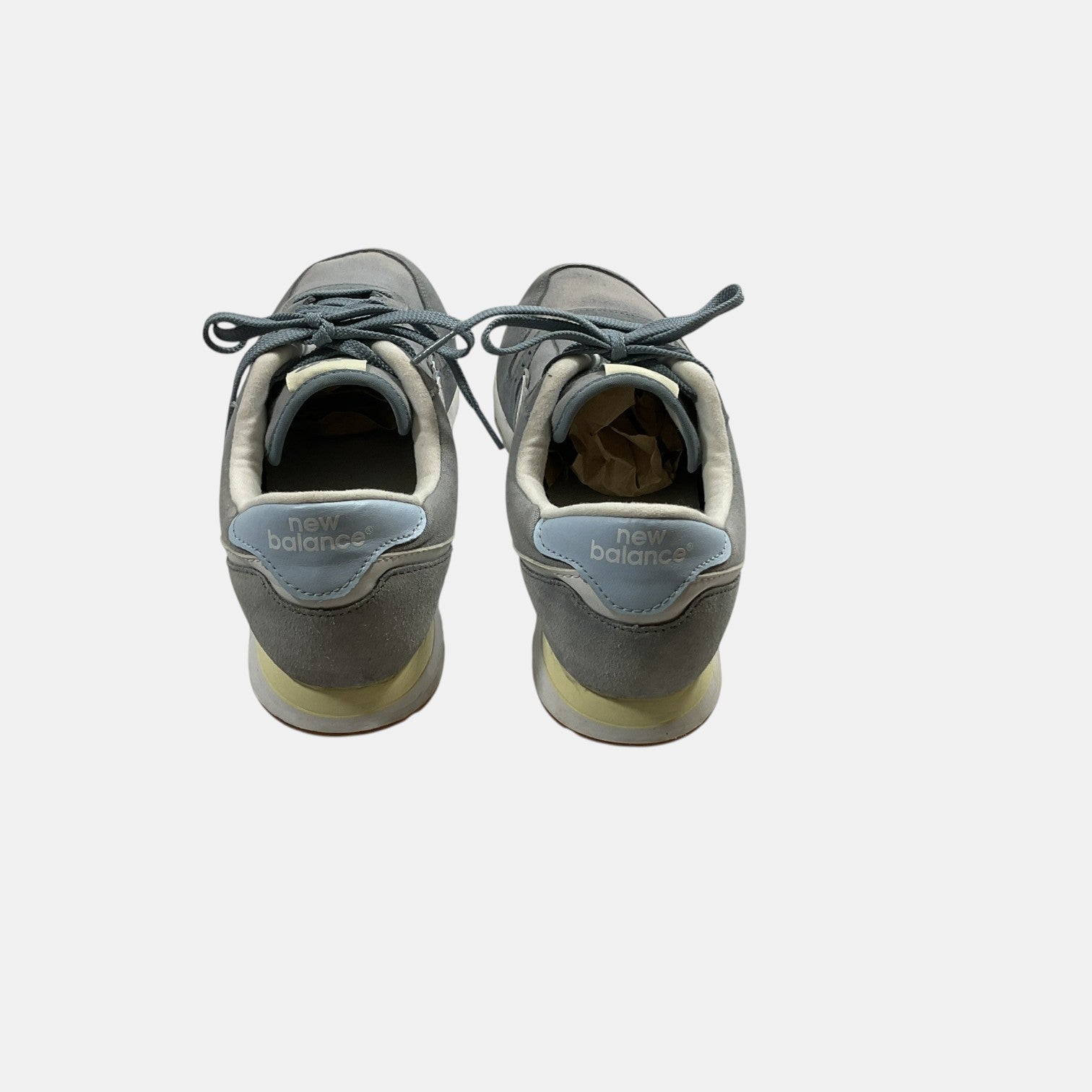 grey and blue New Balance Sneakers on a white background