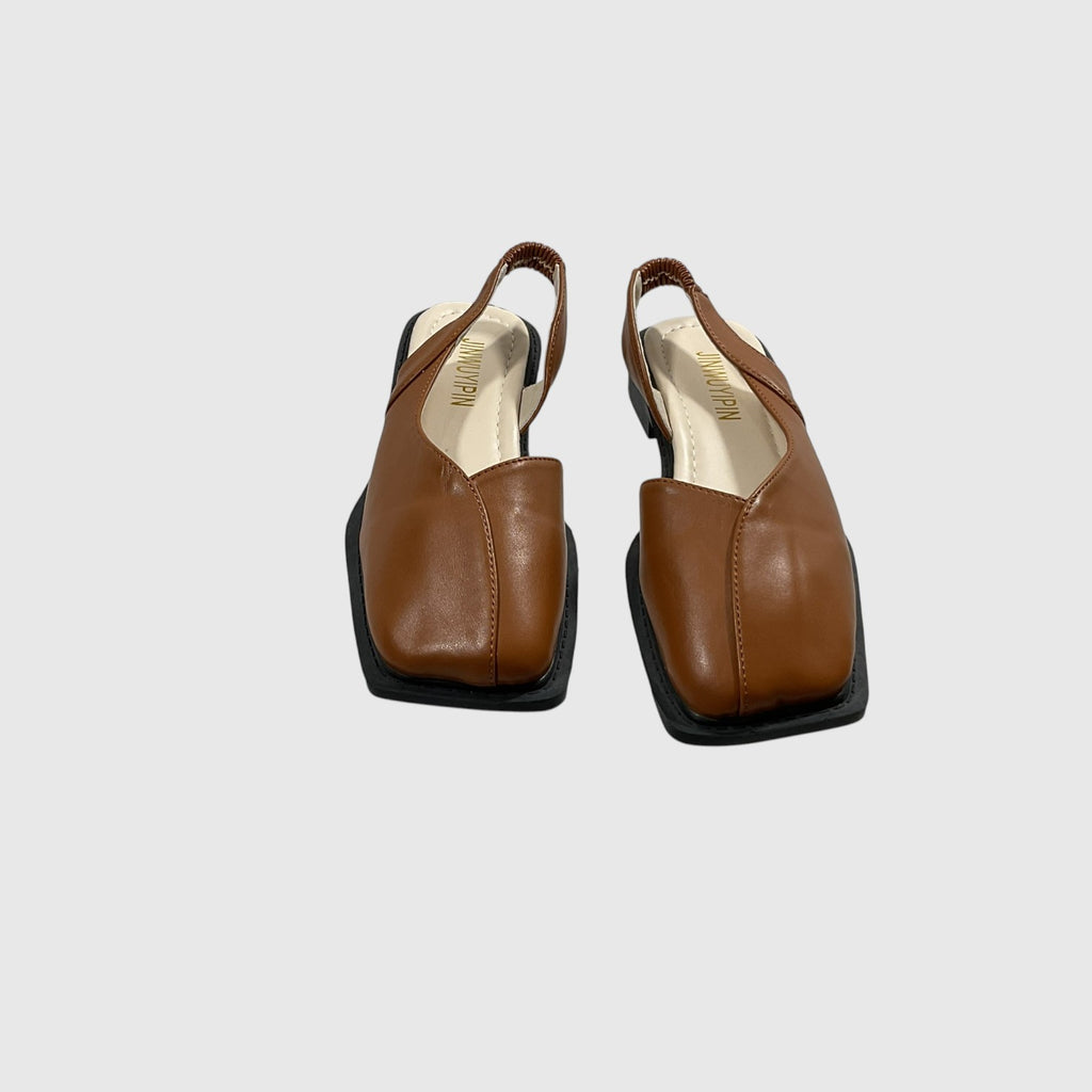 A pair of brown leather slingback flats with square toes and black soles, shown from a top-down view on a light gray background.