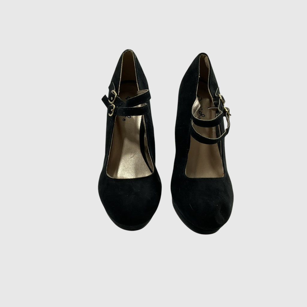 A pair of black suede Mary Jane pumps with gold-tone buckle straps, shown from a top-down view on a light gray background.