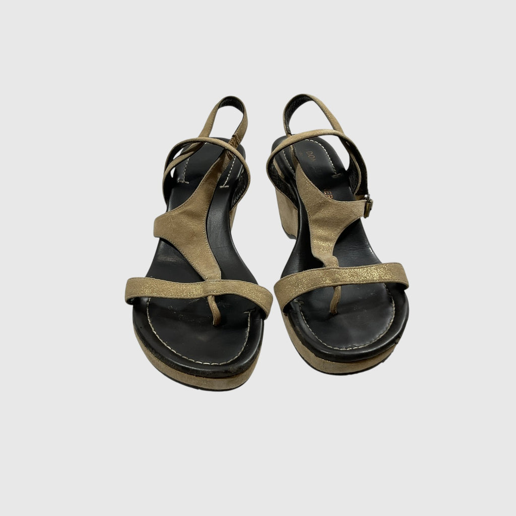 A pair of women's platform sandals with metallic gold straps and a black footbed, shown from a top-down view on a light gray background.