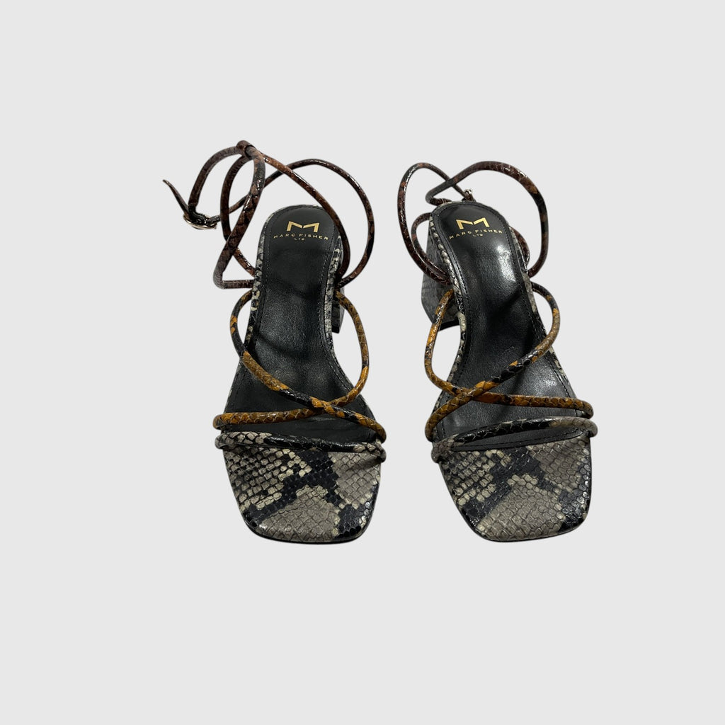 A pair of women's heeled sandals featuring a snakeskin-patterned toe strap, black leather straps, and a thin brown leather wrap-around strap, shown against a light gray background.