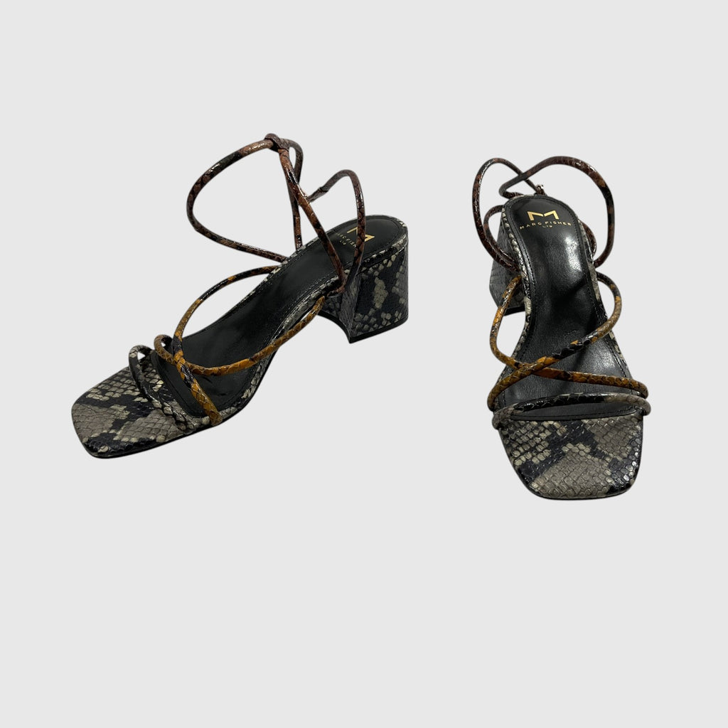 A pair of women's block-heel sandals featuring a black and gray snakeskin pattern on the footbeds and straps, accented with brown snakeskin detailing and a small gold logo on the insole.