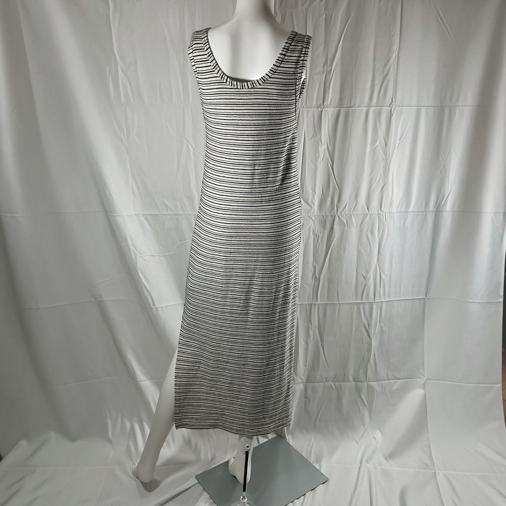 A sleeveless, scoop-neck maxi dress with thin horizontal black and white stripes, displayed on a white mannequin against a wrinkled white fabric backdrop.