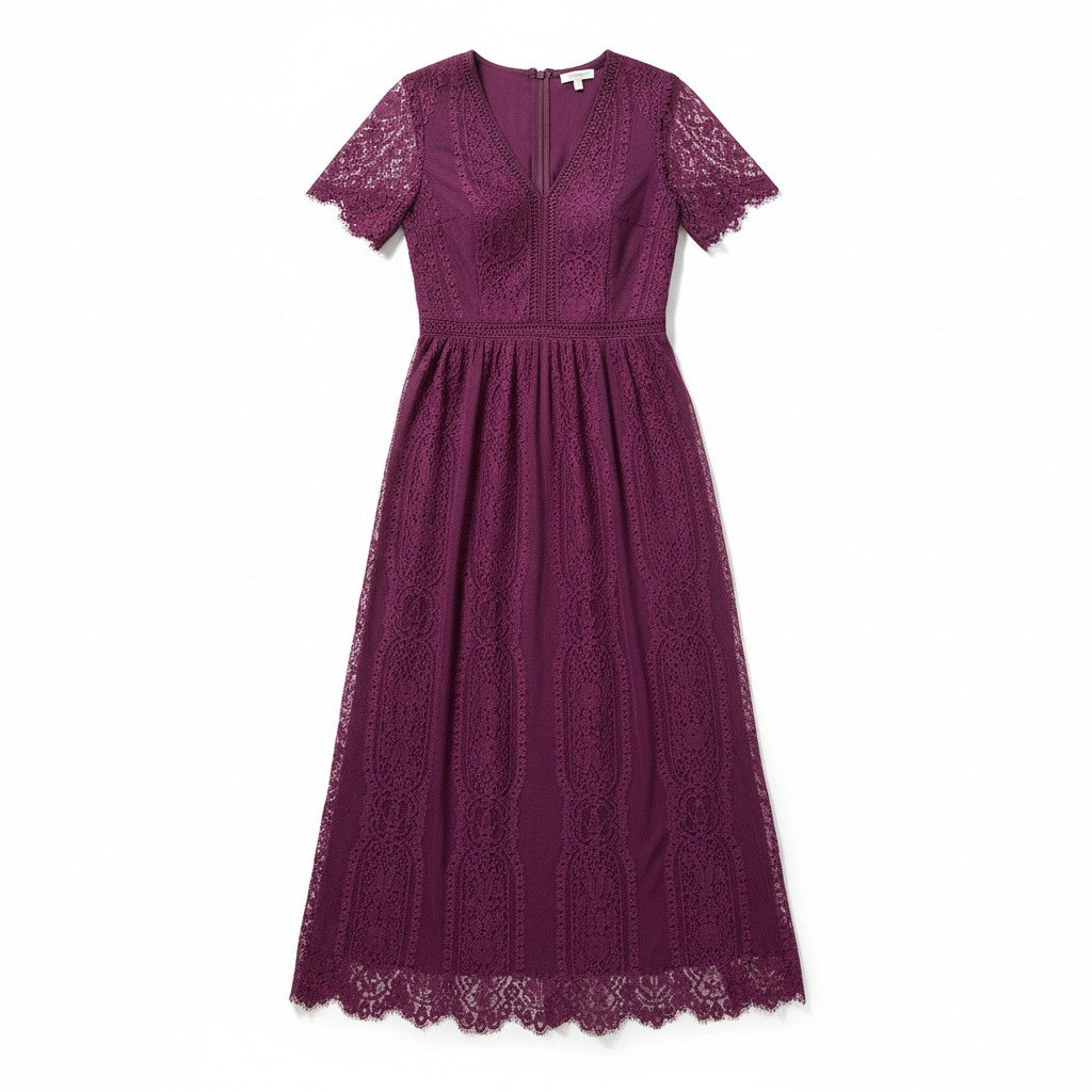 A woman viewed from the back wearing a short-sleeve midi dress in deep burgundy lace, paired with black strappy heels, against a light gray studio background.