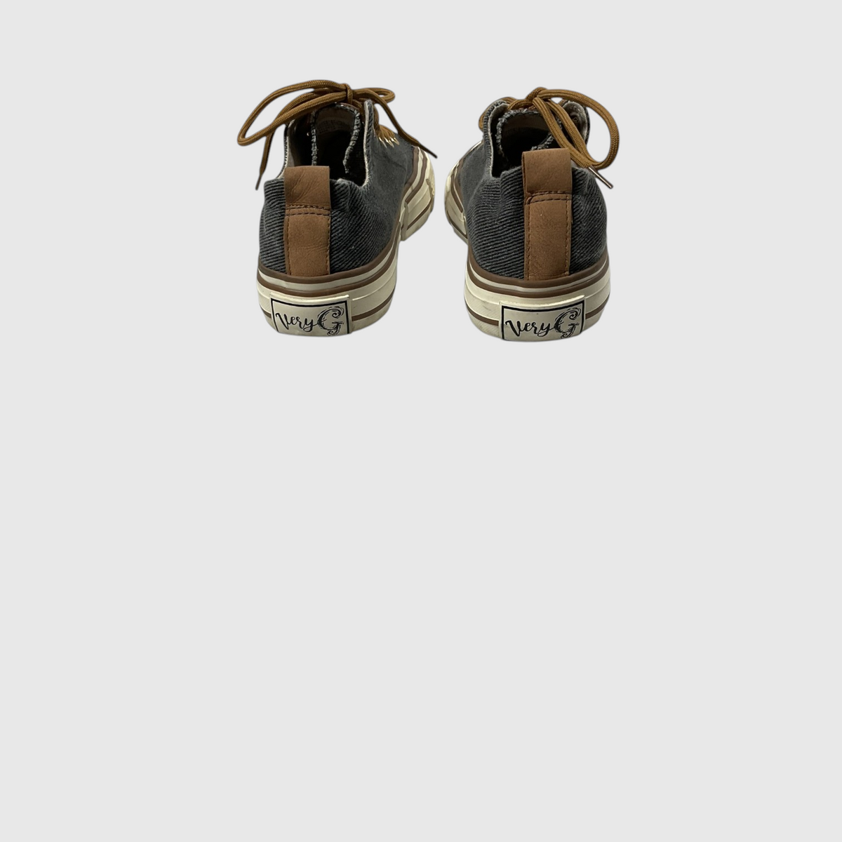 Pair of gray sneakers with white laces on a light gray background
