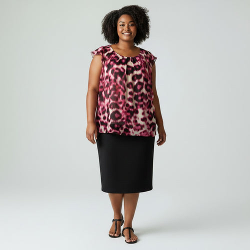A woman modeling a sleeveless top with a pink, red, and black leopard print pattern, paired with a black knee-length skirt and black sandals, against a light gray studio background.