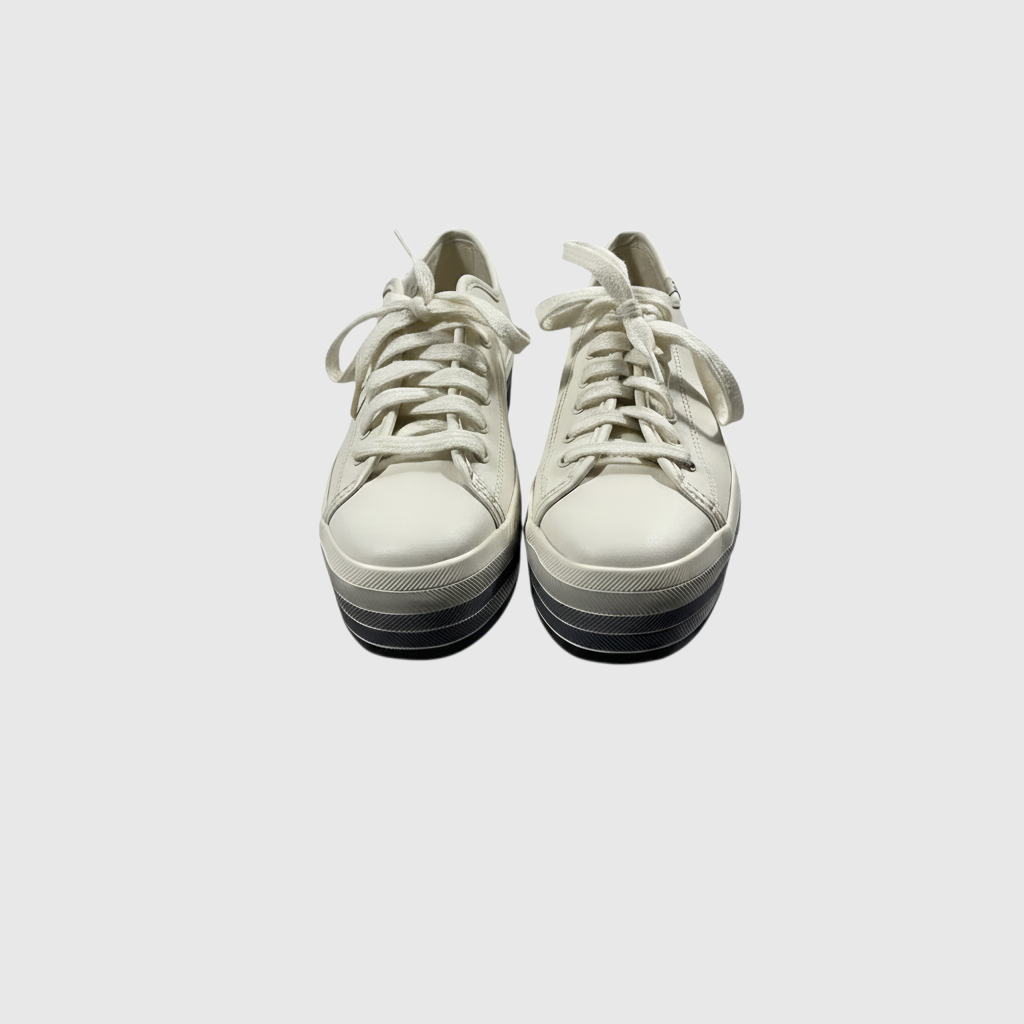 A pair of low-top platform sneakers in off-white leather with matching laces, featuring a chunky black and white striped platform sole, shown against a light gray background.