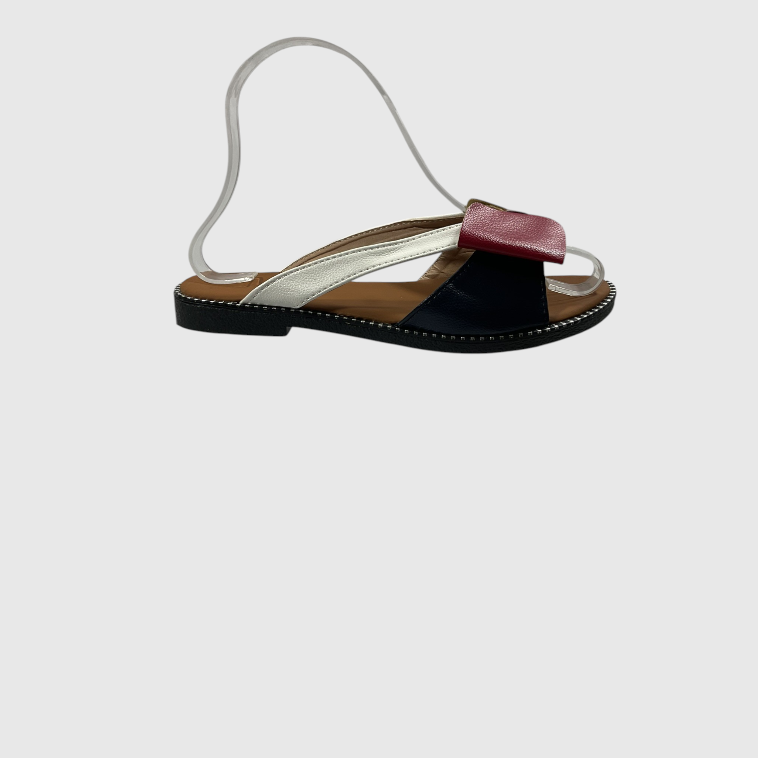 A single women's flat sandal with a metallic silver strap, a black toe strap, a burgundy leather accent, and a thin silver ankle strap, shown against a light gray background.