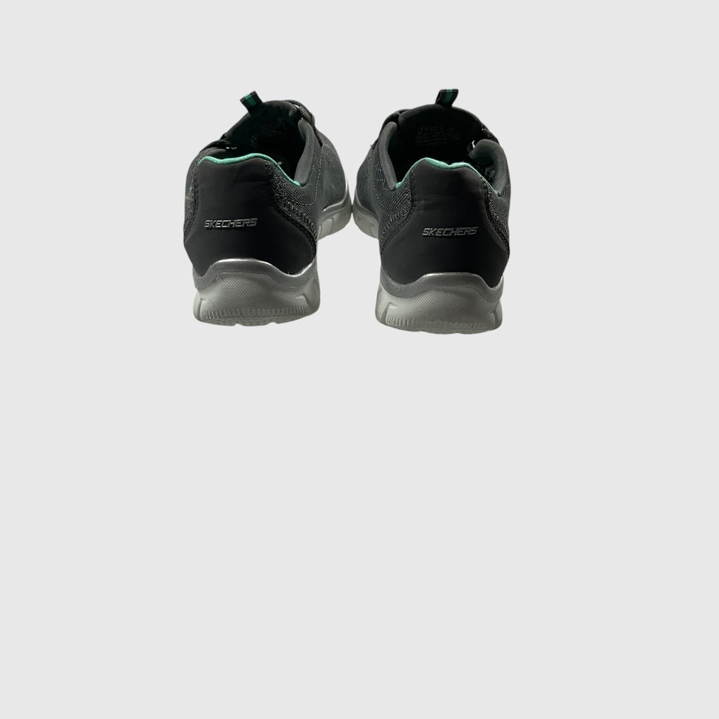 A gray, pink, and turquoise sneaker on a light gray background.