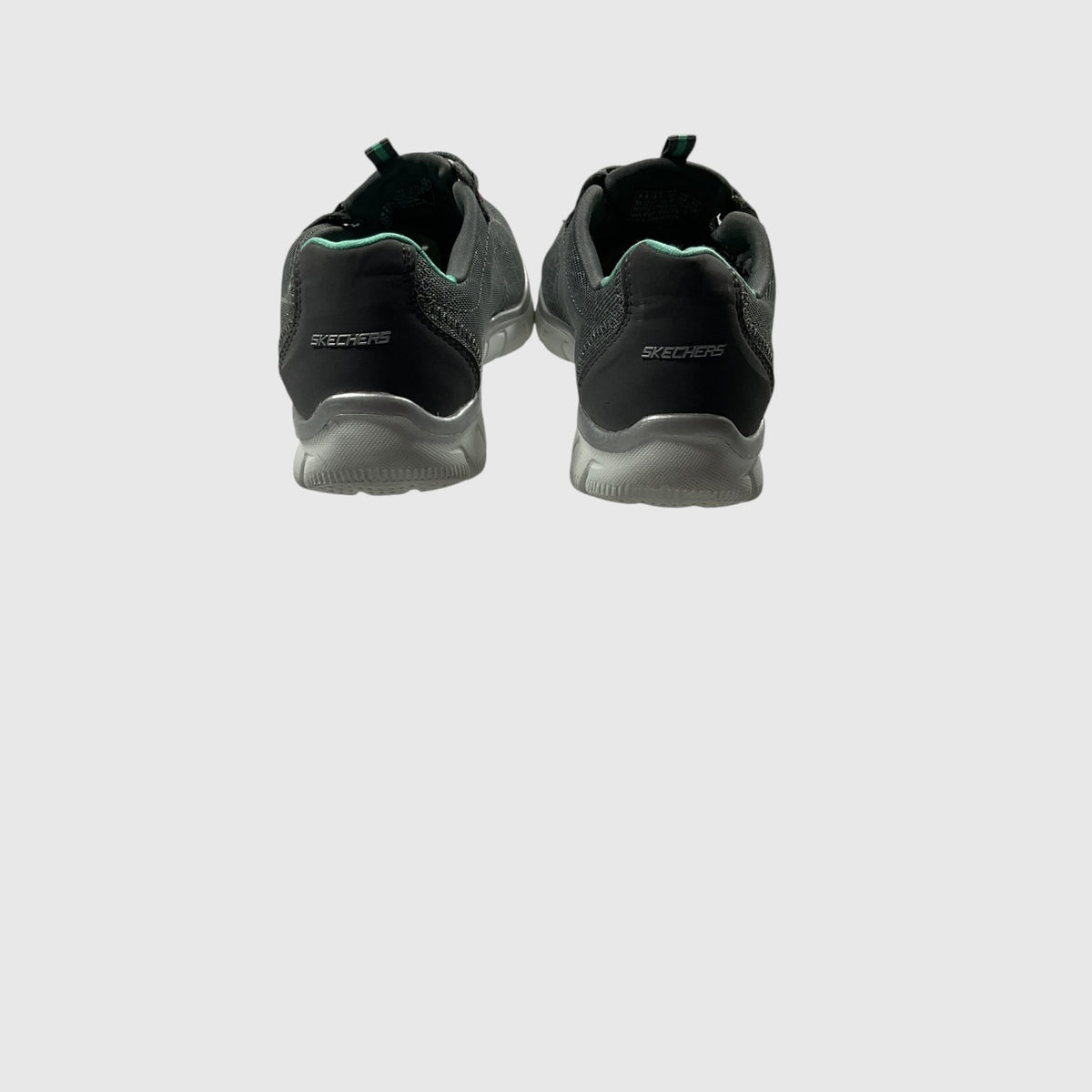 A gray, pink, and turquoise sneaker on a light gray background.