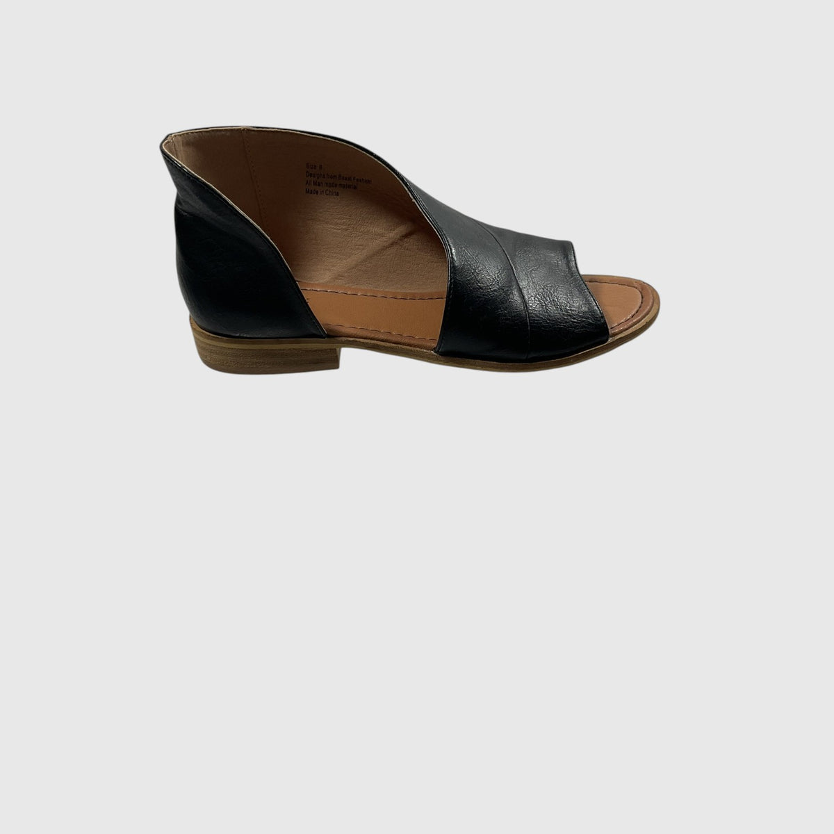A single black leather peep-toe flat sandal with a low brown block heel, shown from a side profile view against a light gray background.