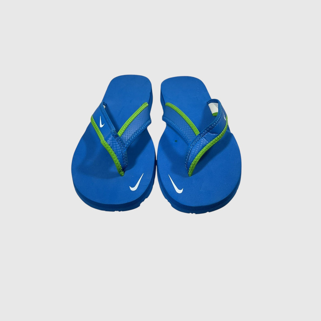 A pair of blue and green flip flops on a light gray background.