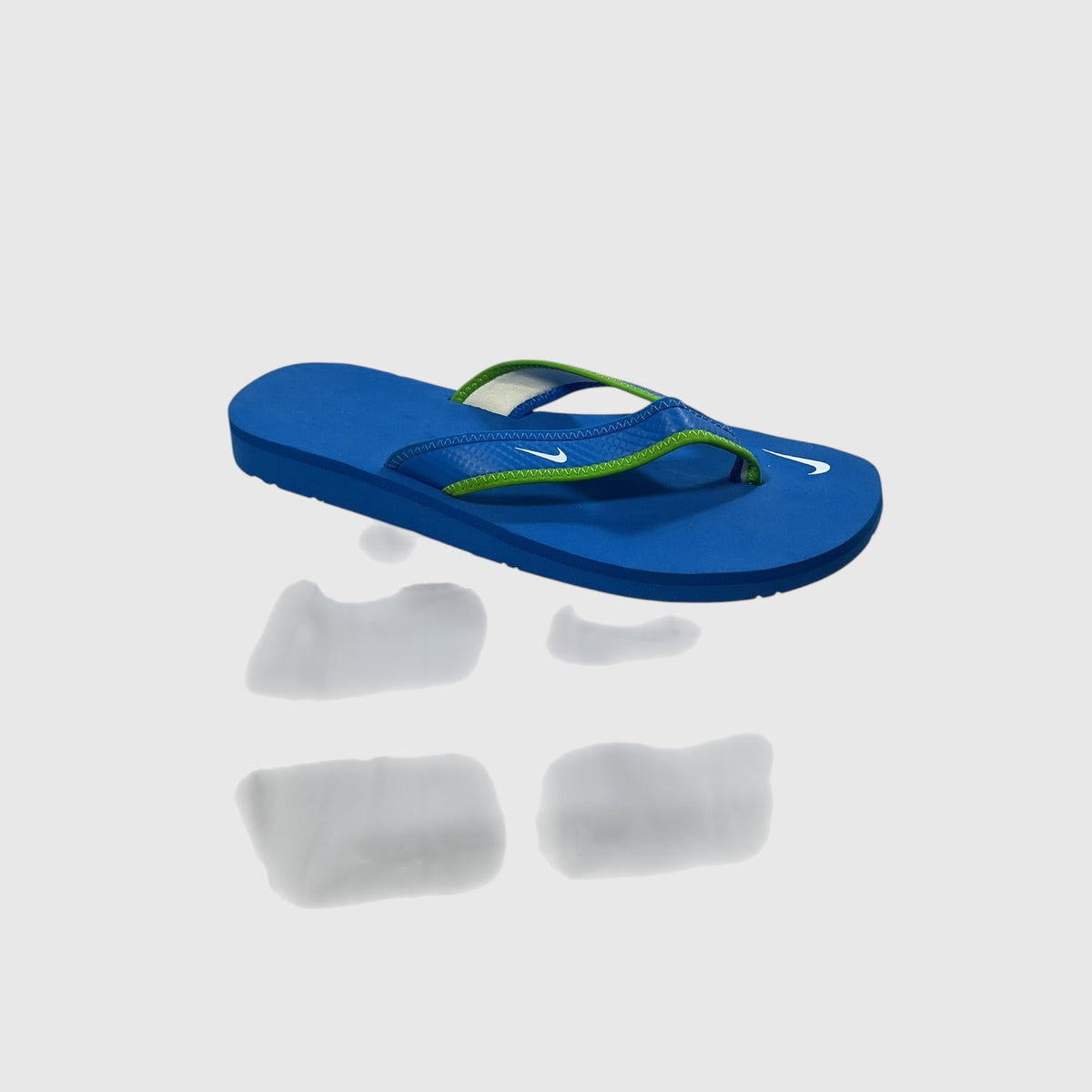 A pair of blue and green flip flops on a light gray background.