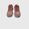 A pair of Nike running shoes in a dusty rose pink color, featuring a breathable mesh upper and white soles, shown from a front-facing perspective on a light gray background.