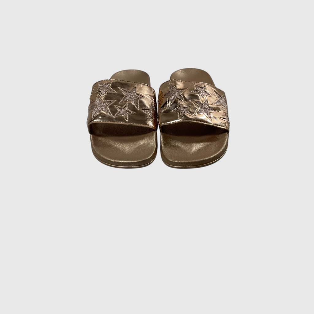 A pair of metallic gold slide sandals with embroidered star patterns on the straps, shown from a top-down view on a light gray background.