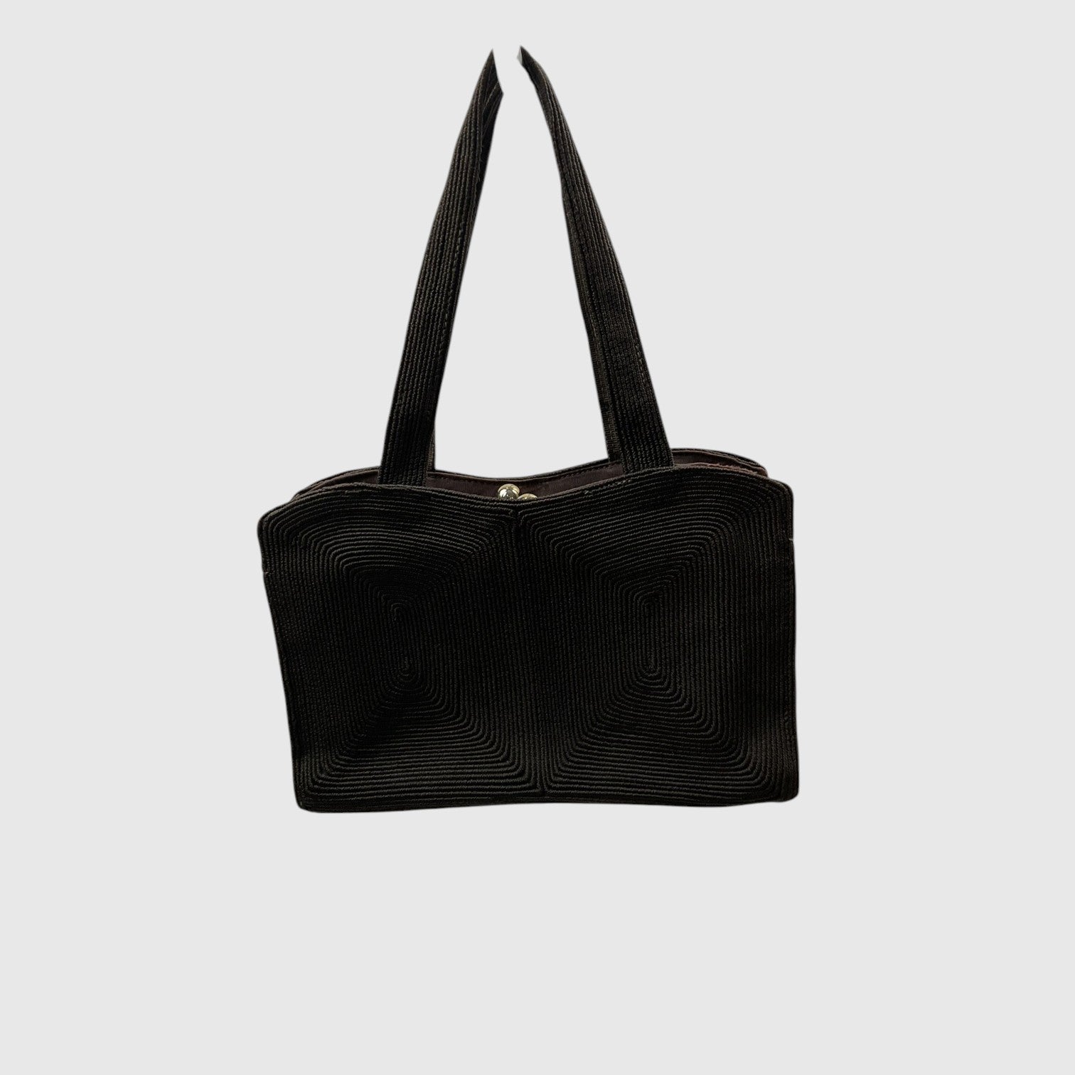 A black textured shoulder bag with a ribbed corduroy-like finish and two long handles, shown against a plain light gray background.