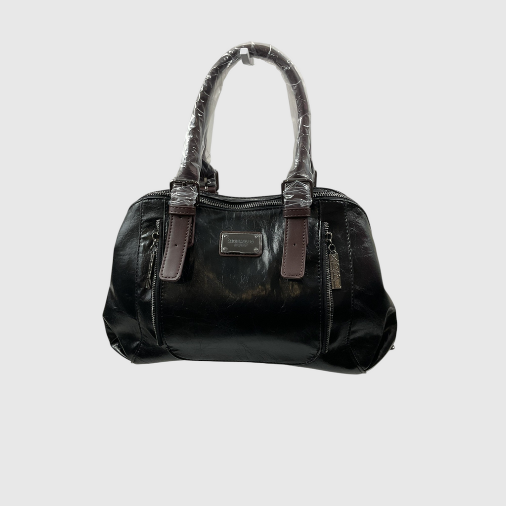 A black glossy patent leather handbag with brown leather trim and a silver-tone metal plaque on the front, shown against a light gray background.