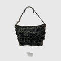A Coach hobo shoulder bag in black coated canvas with the signature monogram logo pattern in dark gray and black, featuring gold-tone hardware and a matching shoulder strap.