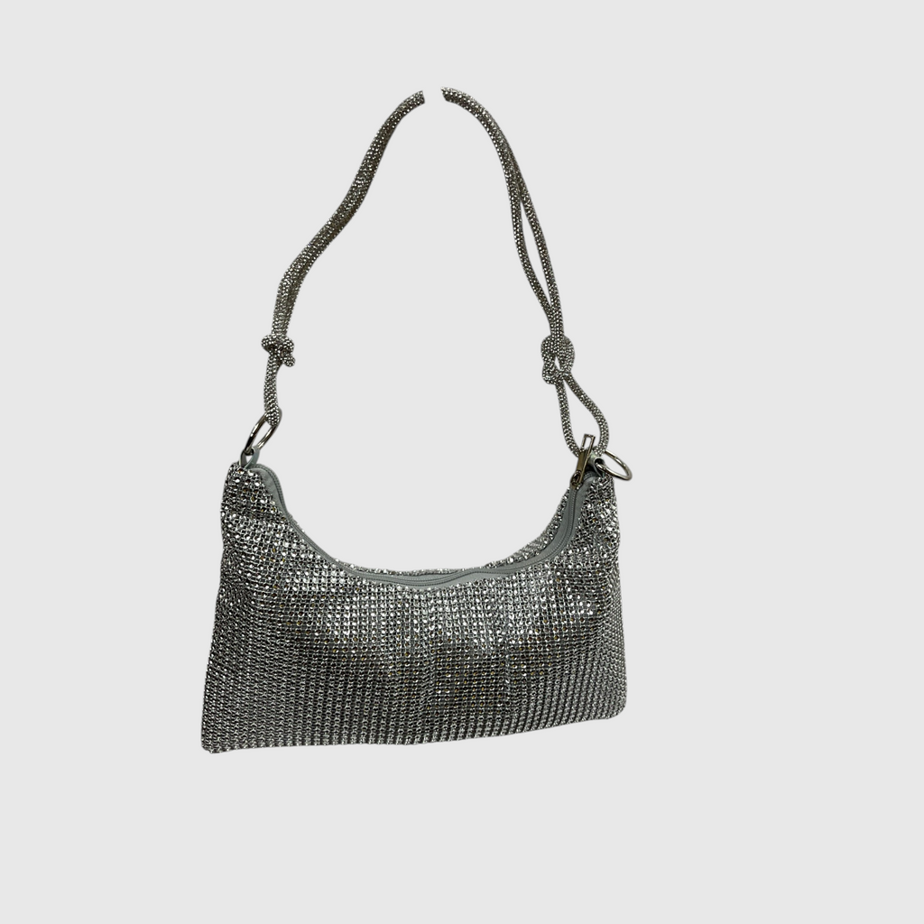 A silver rhinestone-embellished shoulder bag with a matching rhinestone-strap, shown against a solid light gray background.