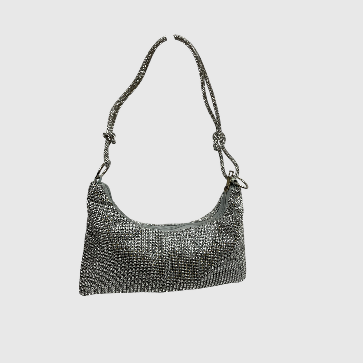 A silver rhinestone-embellished shoulder bag with a matching rhinestone-strap, shown against a solid light gray background.
