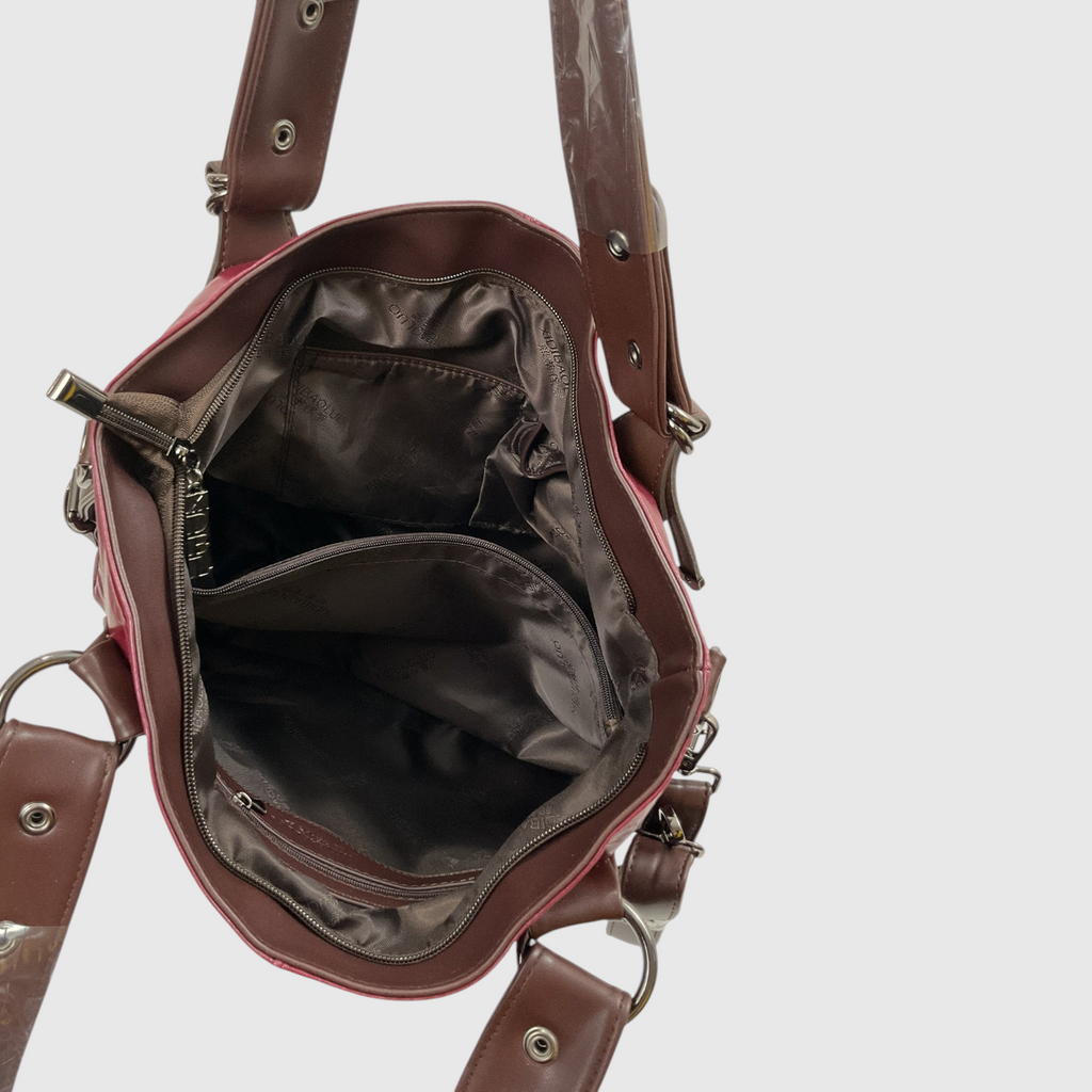 An open brown leather handbag showing its interior compartments, lining, and adjustable shoulder straps with metal rivets, photographed against a light gray background.