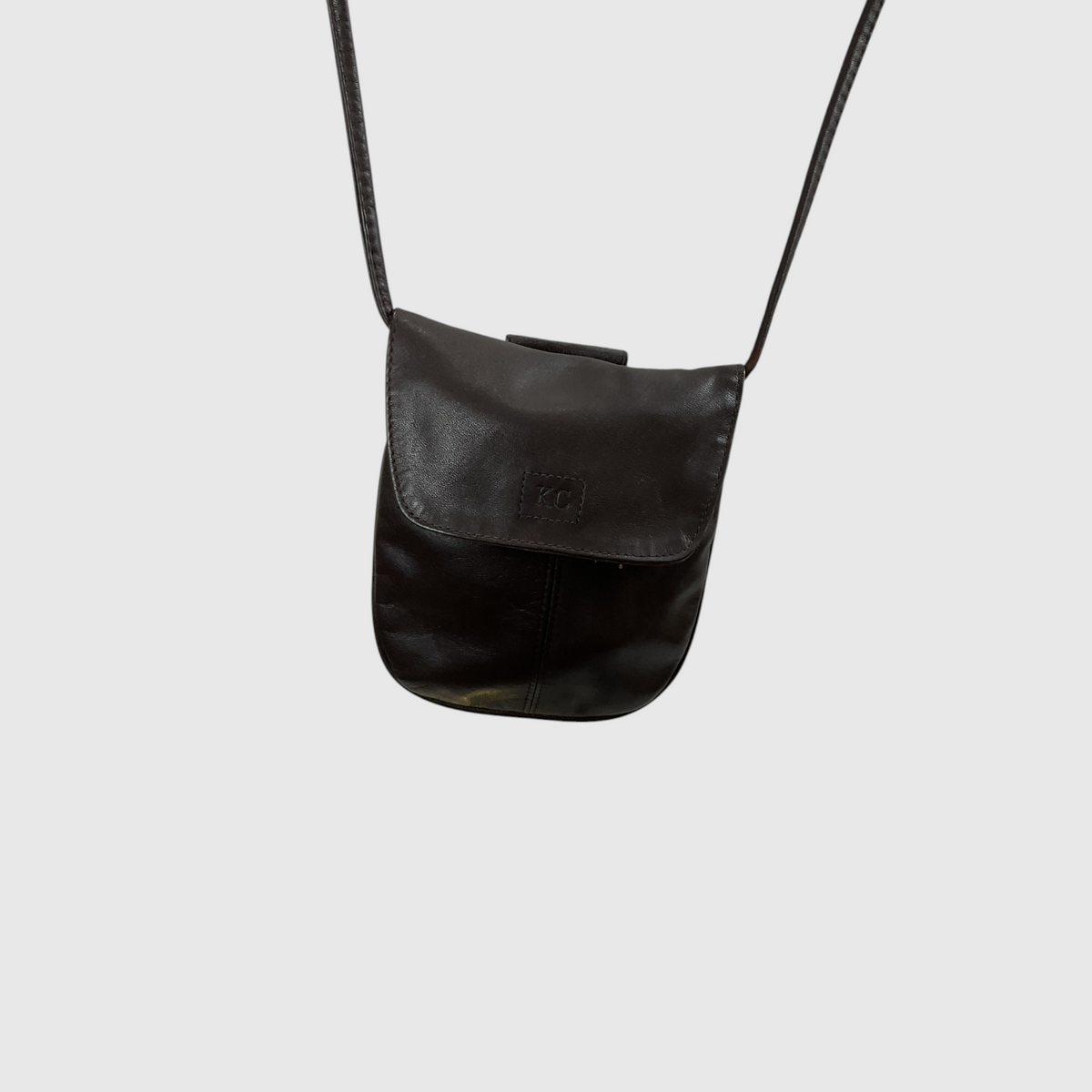 The Solid Smooth Faux Leather  Mini Crossbody Bag against a gray background.