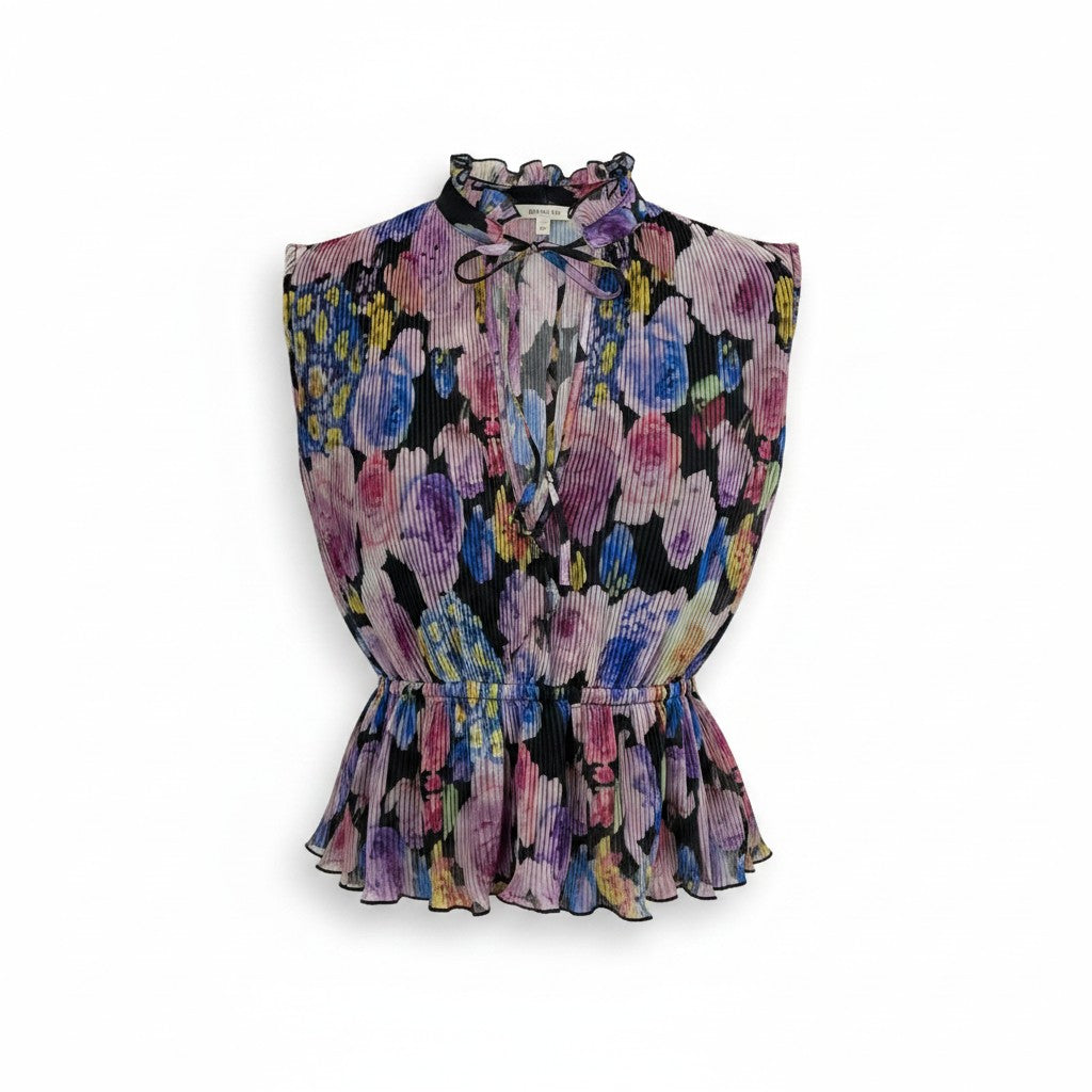 A sleeveless pleated blouse with a high ruffled collar, tie-front detail, and a peplum waist, featuring a vibrant multicolor floral print on a black background.