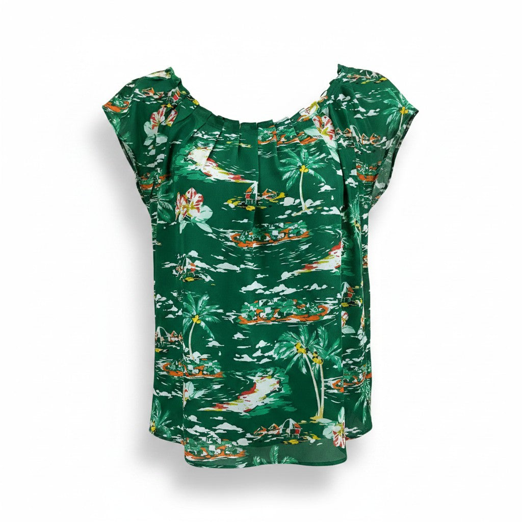 A green short-sleeve top with a tropical print featuring palm trees, birds, and small boats, displayed against a white background.
