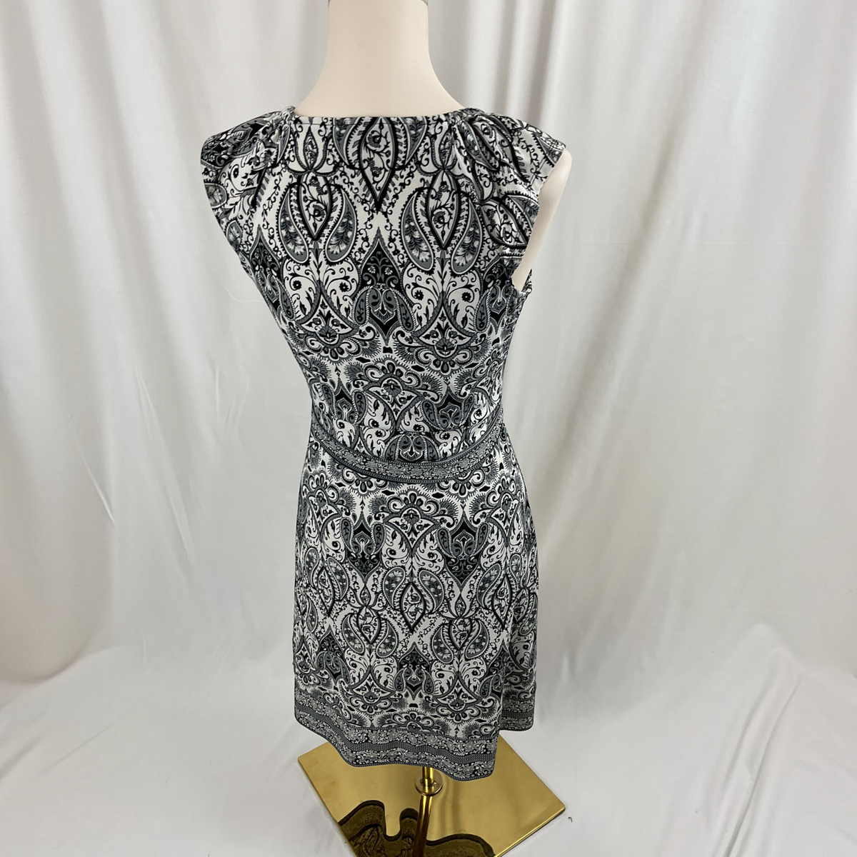A floral sleeveless dress on a light gray background