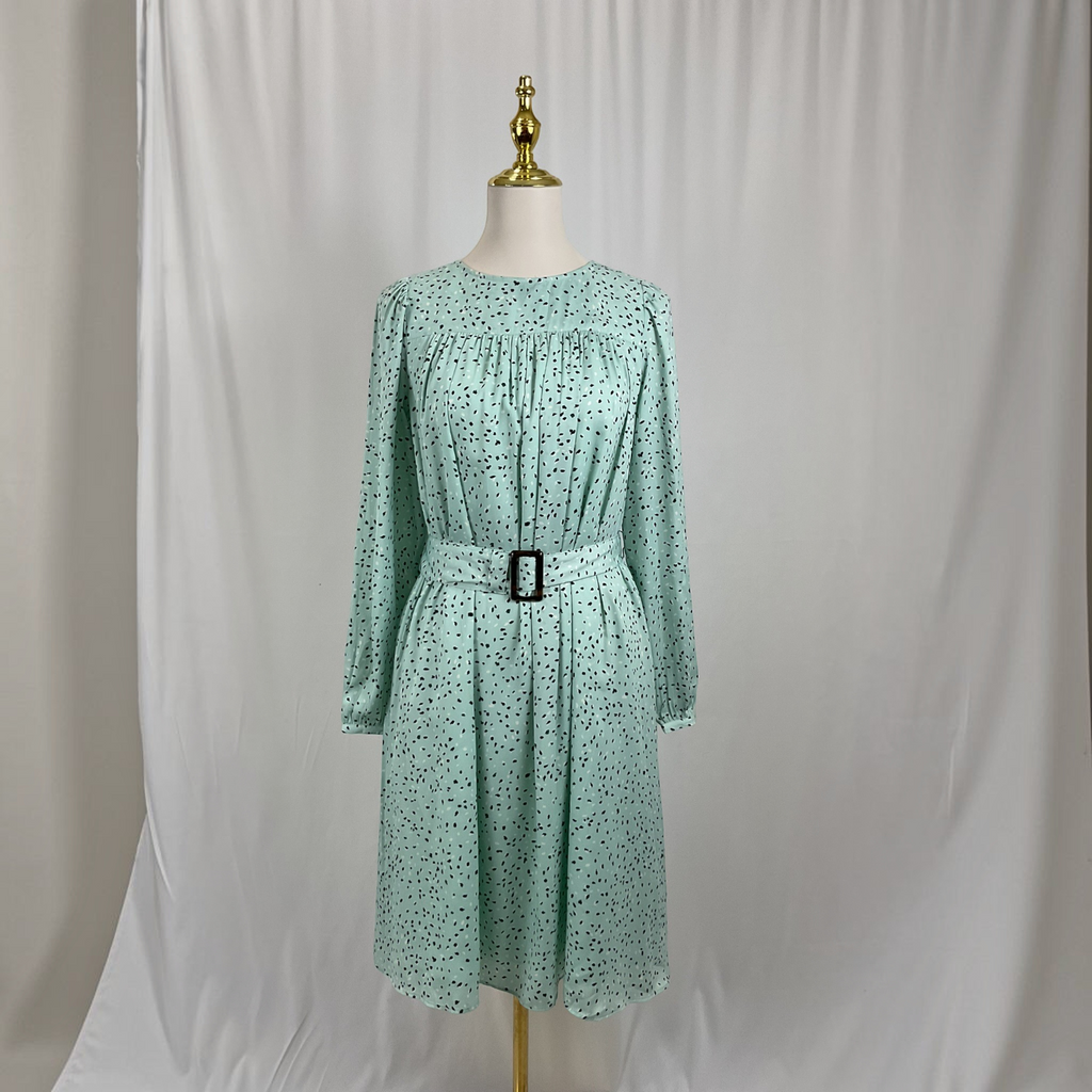A scattered dot dress on a gray studio background
