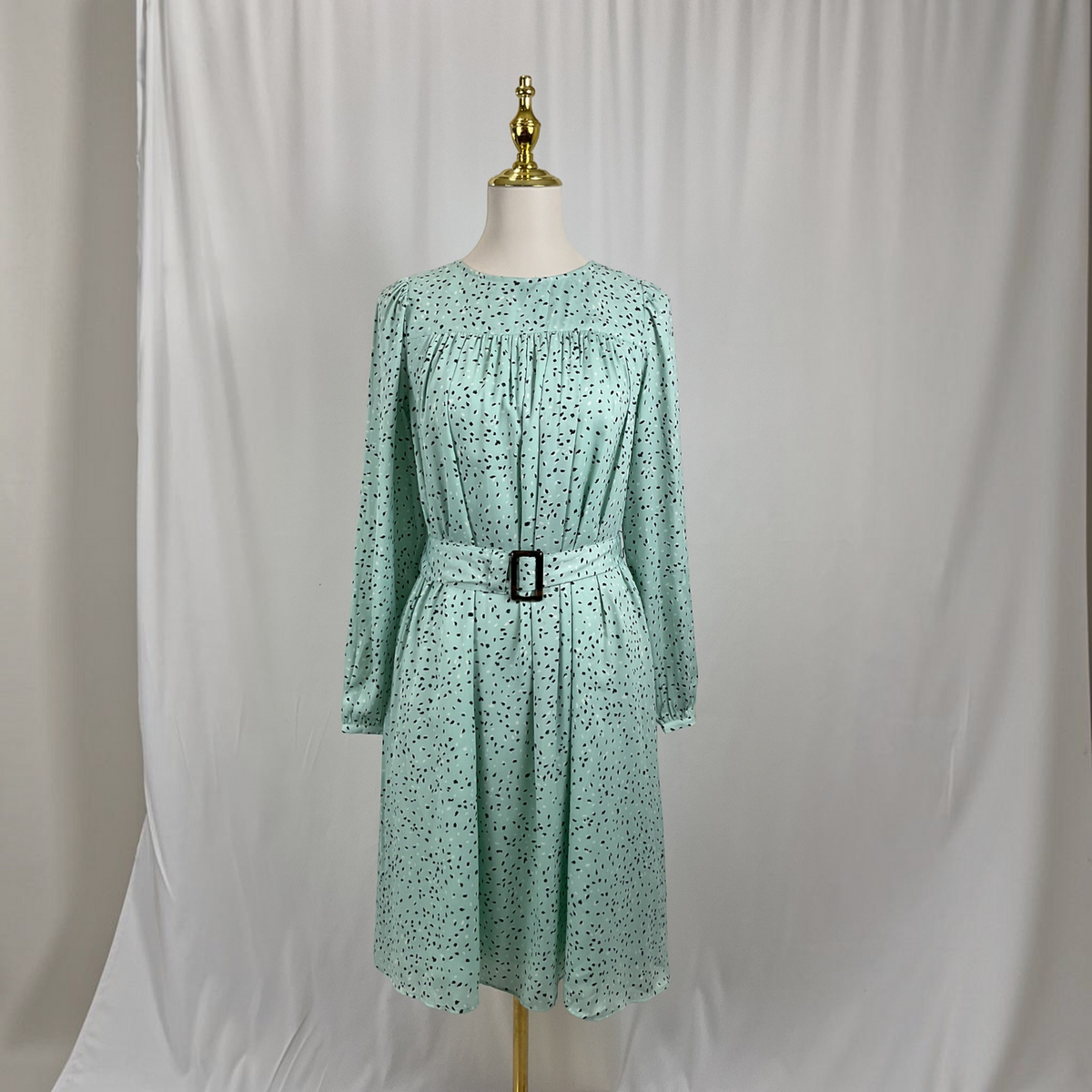 A scattered dot dress on a gray studio background